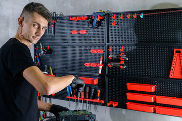 Professional repairman repairing computer in workshop