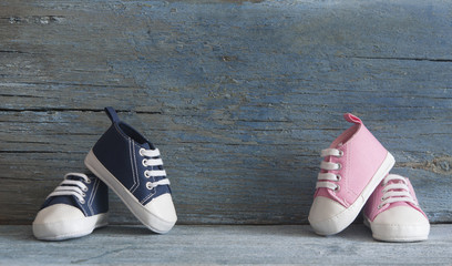 Cute tiny baby shoes on a wood with copy space for your text