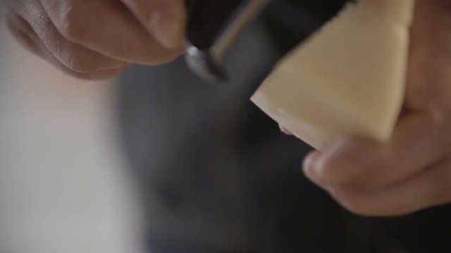 Chef is grating Parmesan