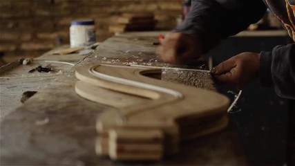 Craftsman Making a Wooden Musical Instrument.