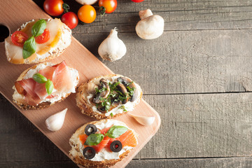 Italian tomato and cheese bruschetta. Tapas, antipasti with chopped vegetables, herbs and oil on grilled ciabatta and baguette bread.