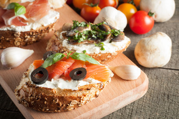 Italian tomato and cheese bruschetta. Tapas, antipasti with chopped vegetables, herbs and oil on grilled ciabatta and baguette bread.