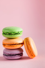 Still life and food photo of cake macarons in a gift box with flowers, a cup of tea on light background. Sweets and desserts concept of macaroons.
