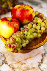 Grapes and apples in a wooden bowl