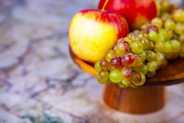 Grapes and apples in a wooden bowl