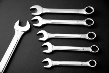 Wrenches on a black background. Tools for repairing.Black and white, monochrome.