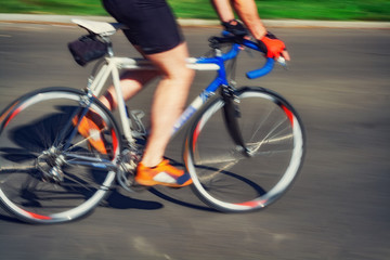 Fototapeta na wymiar Racing bicycle in blurred motion speeding down the road.