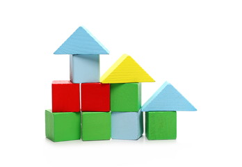 Wooden building blocks for children, made into houses isolated on white background 