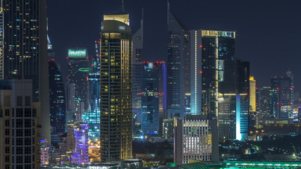 Aerial cityscape timelapse at night with illuminated modern architecture in Downtown of Dubai, United Arab Emirates.