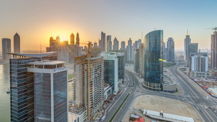 Dubai business bay towers at sunset aerial timelapse.