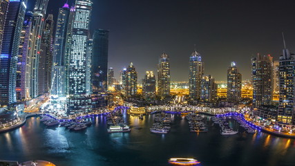 Fototapeta na wymiar Dubai Marina at night timelapse, Glittering lights and tallest skyscrapers during a clear evening