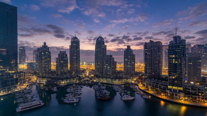 Fototapeta na wymiar Aerial view of modern skyscrapers night to day timelapse before sunrise in Dubai Marina in Dubai, UAE.
