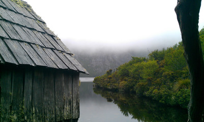 Fototapeta na wymiar Wooden hut on brown Dove Lake
