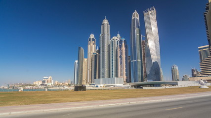Fototapeta na wymiar Scenic view of Dubai Marina Skyscrapers with boats timelapse hyperlapse, Skyline, View from sea, United Arab Emirates