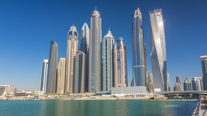 Fototapeta na wymiar Scenic view of Dubai Marina Skyscrapers with boats timelapse, Skyline, View from sea, United Arab Emirates