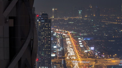Fototapeta na wymiar Dubai Downtown night timelapse modern towers panoramic view from the top in Dubai, United Arab Emirates.