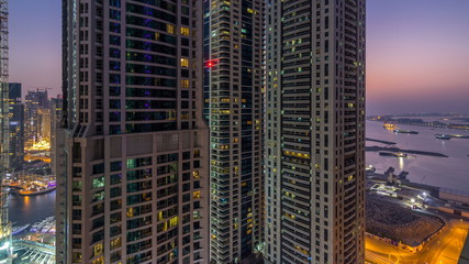 Fototapeta na wymiar Dubai Marina day to night timelapse, Glittering lights and tallest skyscrapers