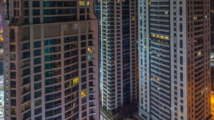 Fototapeta na wymiar Scenic glowing windows of skyscrapers at night timelapse