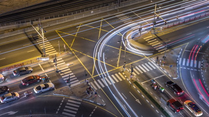Aerial view of a road intersection in a big city night timelapse.
