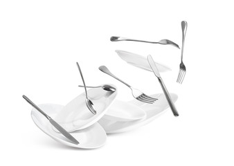 Fall of dishes and cutlery isolated on white background