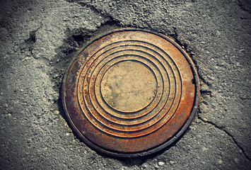 rusty round manhole