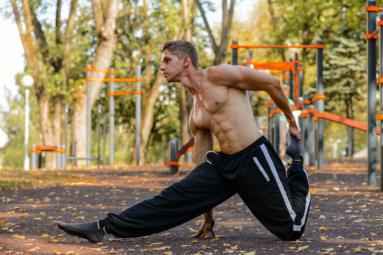 man or guy with muscular body training on stadium outdoor. summer activity and sport. healthy lifestyle