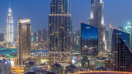 Fototapeta na wymiar Dubai downtown skyline day to night timelapse with tallest building and Sheikh Zayed road traffic, UAE