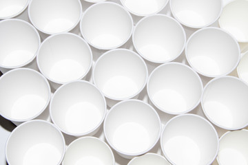 White paper cups for tea on a white background. Isolated objects. Gently hot. Disposable tableware. Dishes for a picnic.