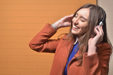 Girl listening to music in big headphones