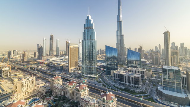 Dubai downtown skyline at sunset timelapse with tallest building and Sheikh Zayed road traffic, UAE