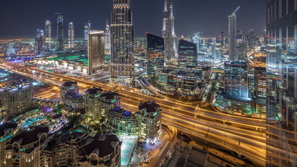 Fototapeta na wymiar Dubai downtown skyline night timelapse with tallest building and road traffic, UAE