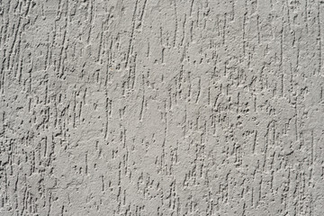 Grey plastered wall with scratches. Background (texture).