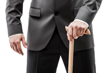Businessman in black suit holding walking cane stick