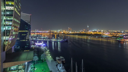 Fototapeta premium Dubai creek landscape night timelapse with boats and ship near waterfront