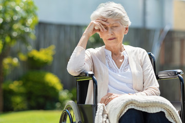 Depressed old woman in wheelchair