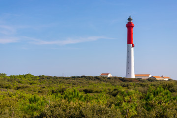 Fototapeta na wymiar White and red tall lighthouse
