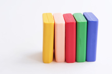 Multicolored polymer clay pieces isolated on the white background.