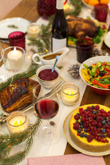 christmas dinner and eating concept - food and drinks on table at home