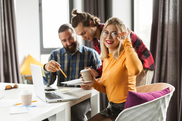 Smile young businesswoman in office. Professional creative people group.