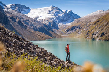 Mountaineer with mountain lake and snow capped mountains