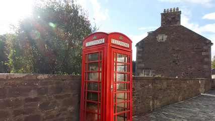 The historic village of New Lanark. A World Heritage Site in a deep valley next to the River Clyde. Red phone box.