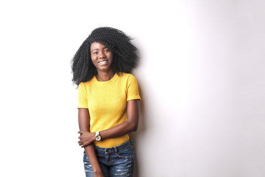 Portrait of smiling young woman in yellow tshirt