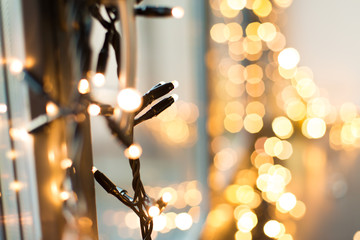 holidays and decoration concept - close up of christmas garland on window