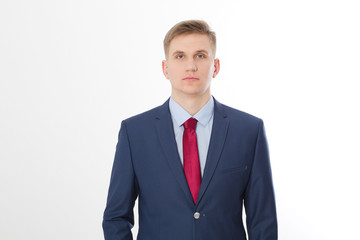 Serious businessman in blue suit and red tie isolated on white background. Business concept. Copy space and mock up