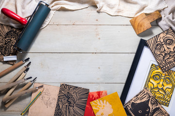 Top view flat lay of Printmaking tools for woodcut relief print arranged to form a picture frame