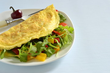 Omelet stuffed from arugula, sweet pepper, copy space