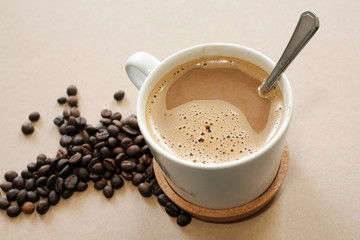 cup of coffee with coffee beans