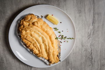 top view on baked dorado under egg whites with herbs