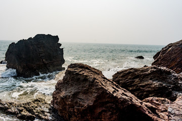 Long exposure shot with silky smooth water and rock in the background at evening.