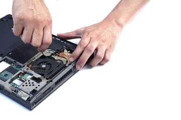 Computer repair concept.Close up the man repair Laptop motherboard with screwdriver. Maintenance...